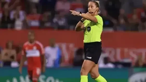 Tori Penso em campo vestindo uniforme de árbitra durante partida