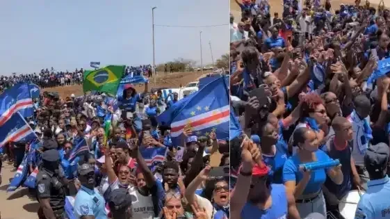 Torcida de Cabo Verde na Cidade da Praia celebrando com bandeiras azuis