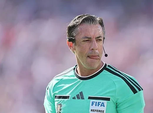 Árbitro Raphael Claus mostrando cartão durante partida na Copa do Mundo