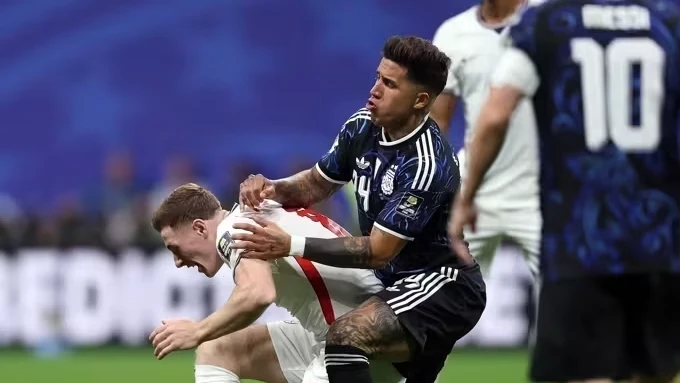 Jogadores das seleções da Espanha e Argentina em ação durante partida, torcida ao fundo