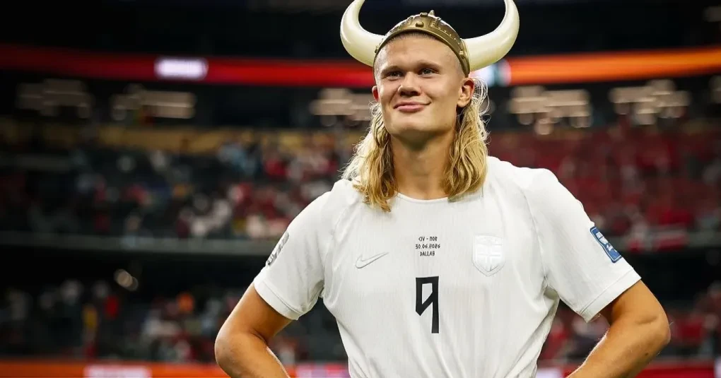 Erling Haaland em campo com a camisa do Manchester City, correndo para finalizar