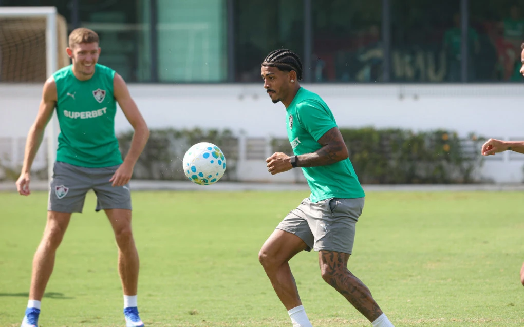 Jogadores do Fluminense em treino coletivo no campo, comissão observando à beira do gramado